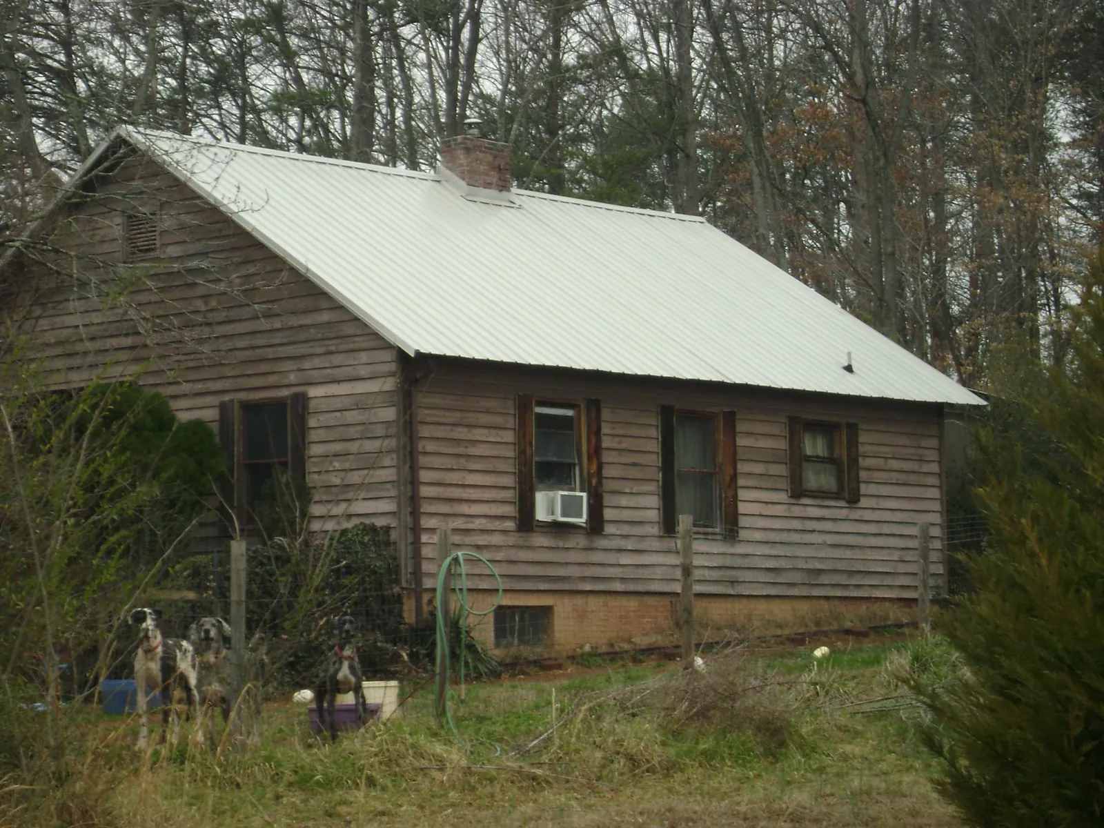 White metal roof on an old wood sided farmhouse, from a Metal Roof Installation job in South Jamesport